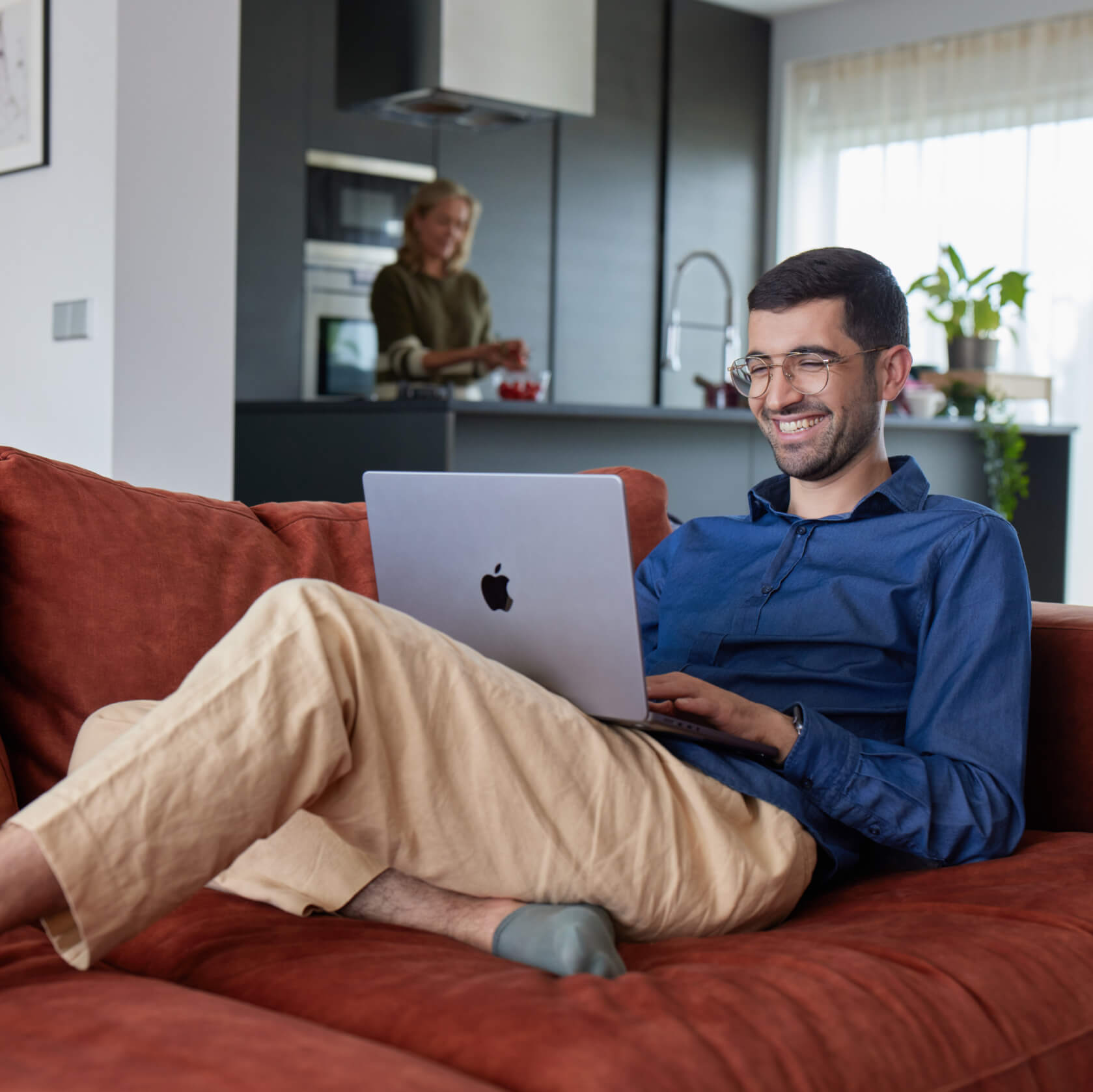 Smiling man browsing on laptop